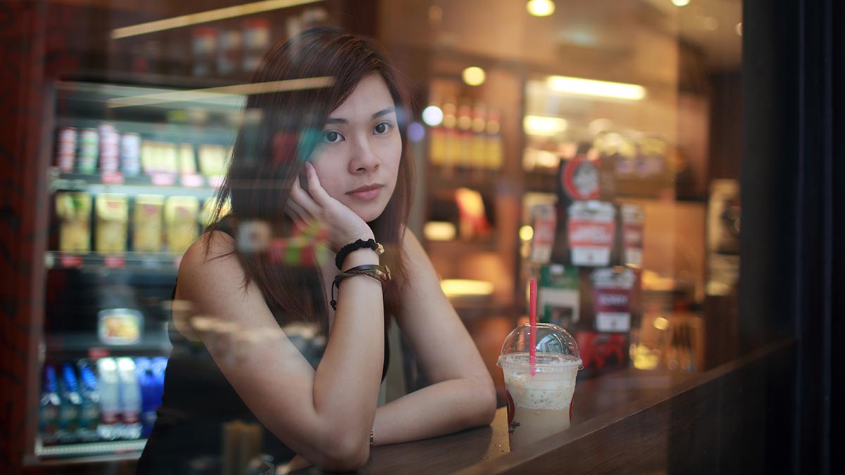 young-girl-looking-out-behind-the-cafe-window.jpg