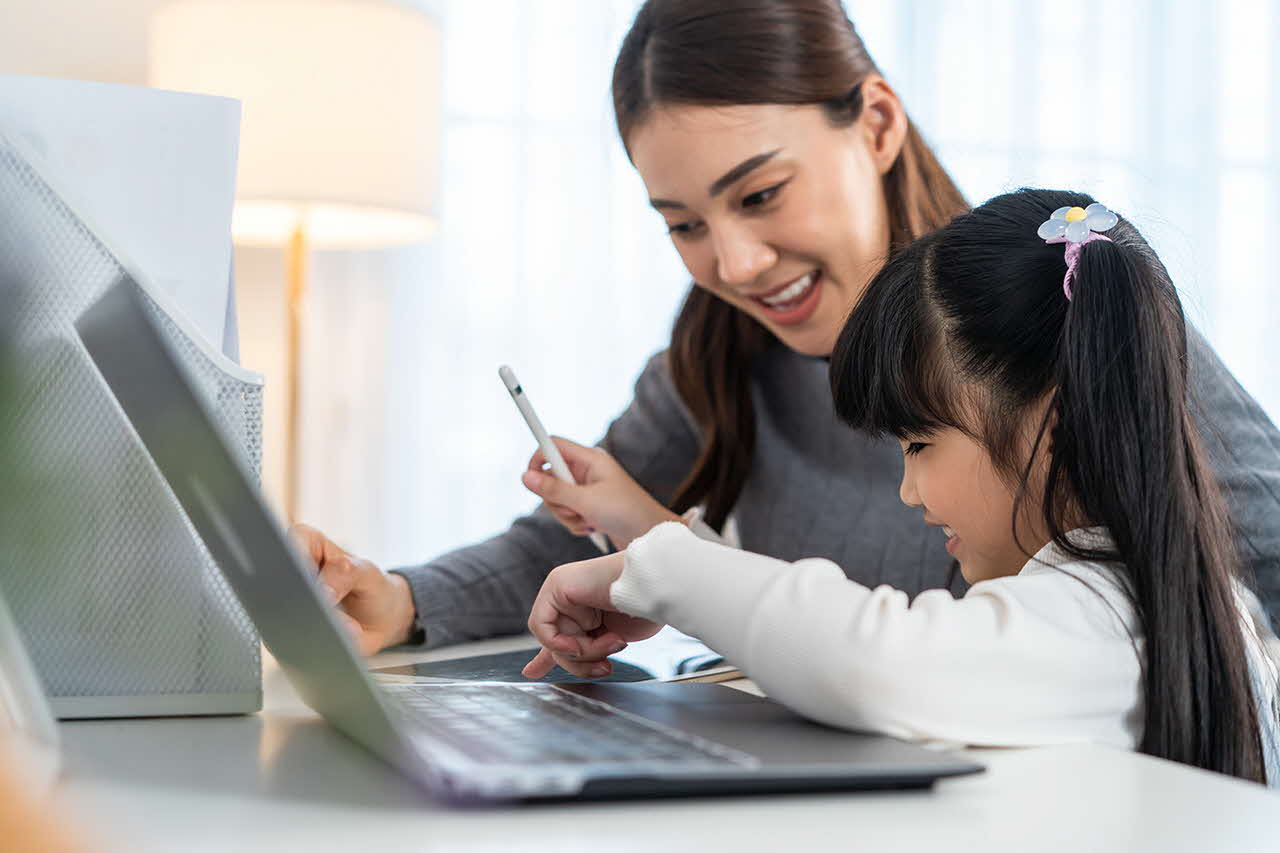 Parent and child in front of a laptop