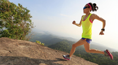 young-woman-trail-runner-running-up-on-mountain-top.jpg