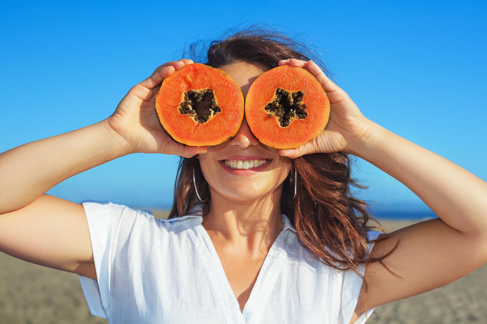 adult-woman-hold-in-hands-ripe-fruit-orange-papaya.jpg