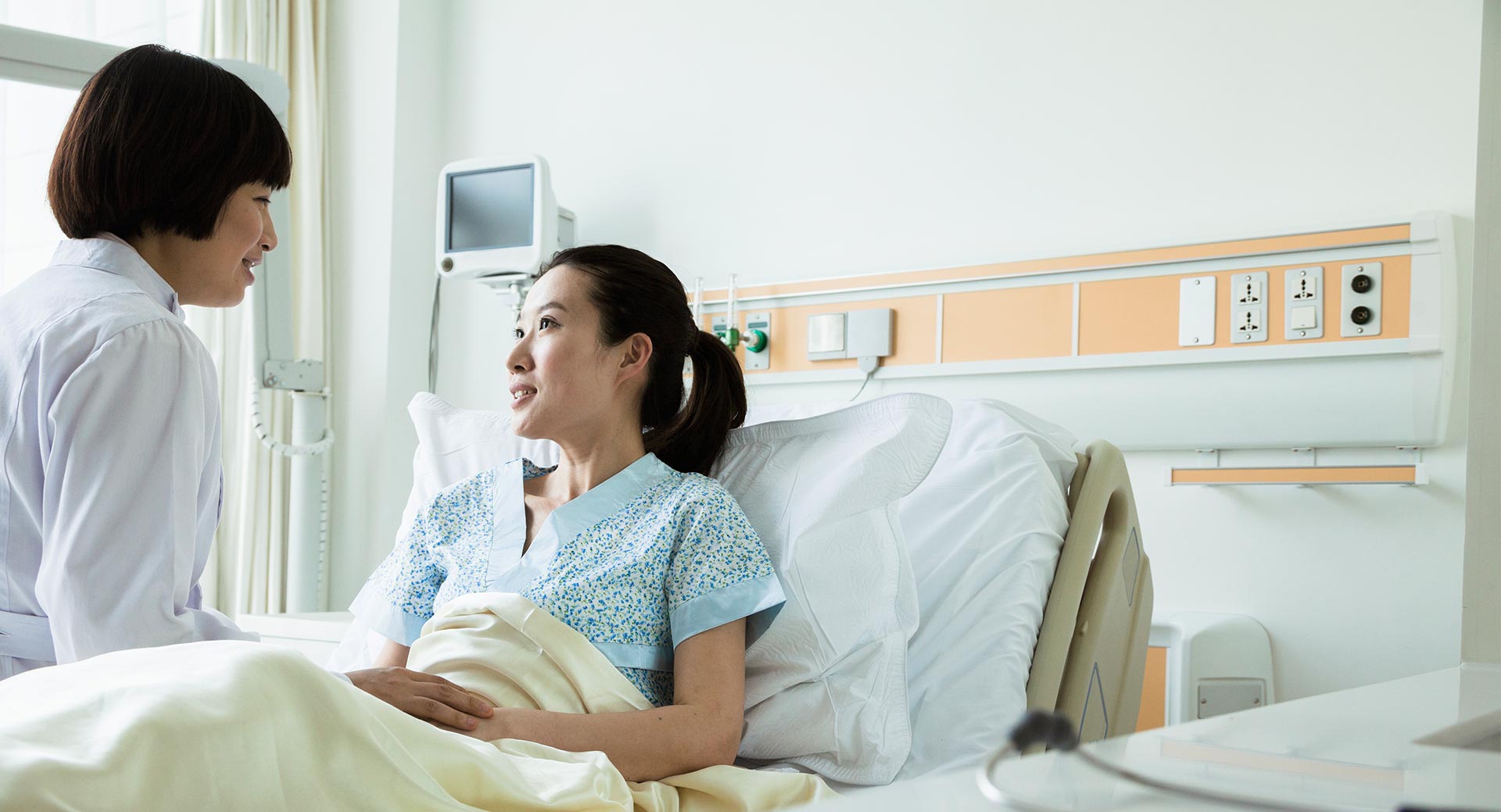 female-asian-doctor-talking-to-young-female-asian-patient-feature.jpg