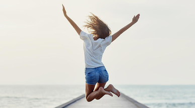 back-view-of-jumping-girl-on-the-pier.jpg