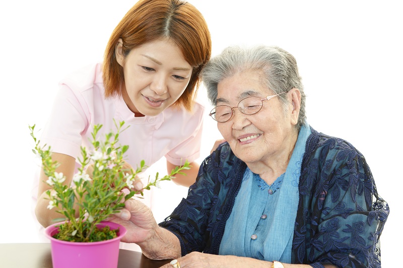Dementia_old lady with plant_shutterstock_149396273.jpg