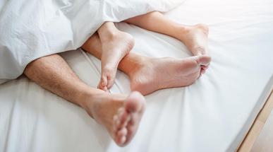 love-lying-in-bed-in-hotel-embracing-on-white-sheets.jpg