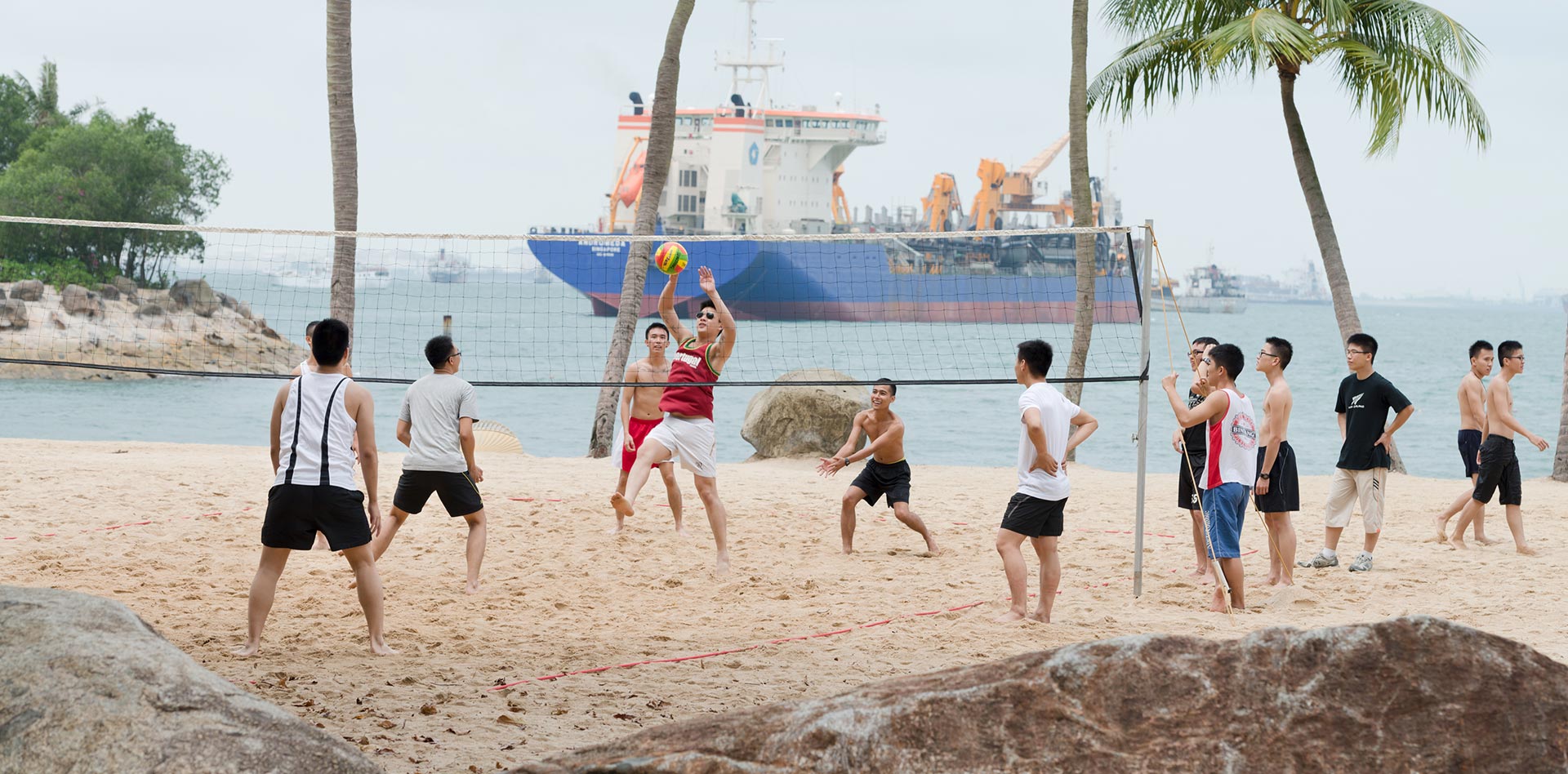 group-of-men-play-volleyball-on-beach.jpg
