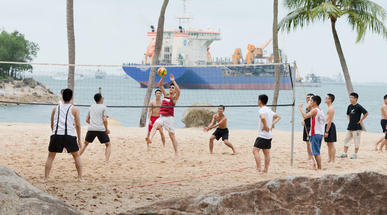 group-of-men-play-volleyball-on-beach.jpg