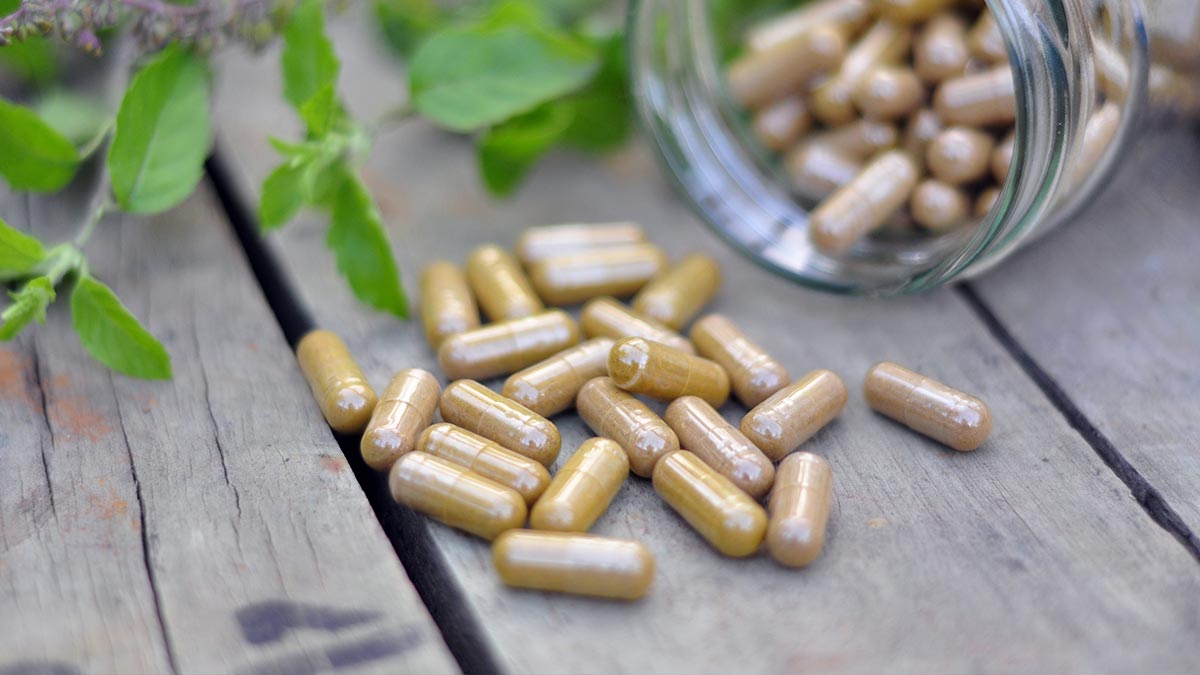 a-full-jar-of-herbal-capsules-tilted-over-and-spilled-oit.jpg