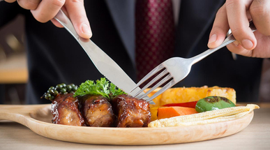businessman-holding-fork-and-knife-eating-steak-business-and-food-concept.jpg