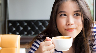 Asian-woman-smiling-and-drinking-coffee.jpg