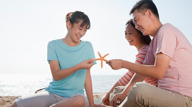 family-sitting-on-the-beach.jpg