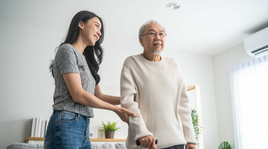 asian-young-daughter-support-senior-older-man-walk-with-walker-home-beautiful-girl-help-take-care-elderly-mature-grandpa-patient-doing-physical-therapy-health-living-room-house.jpg