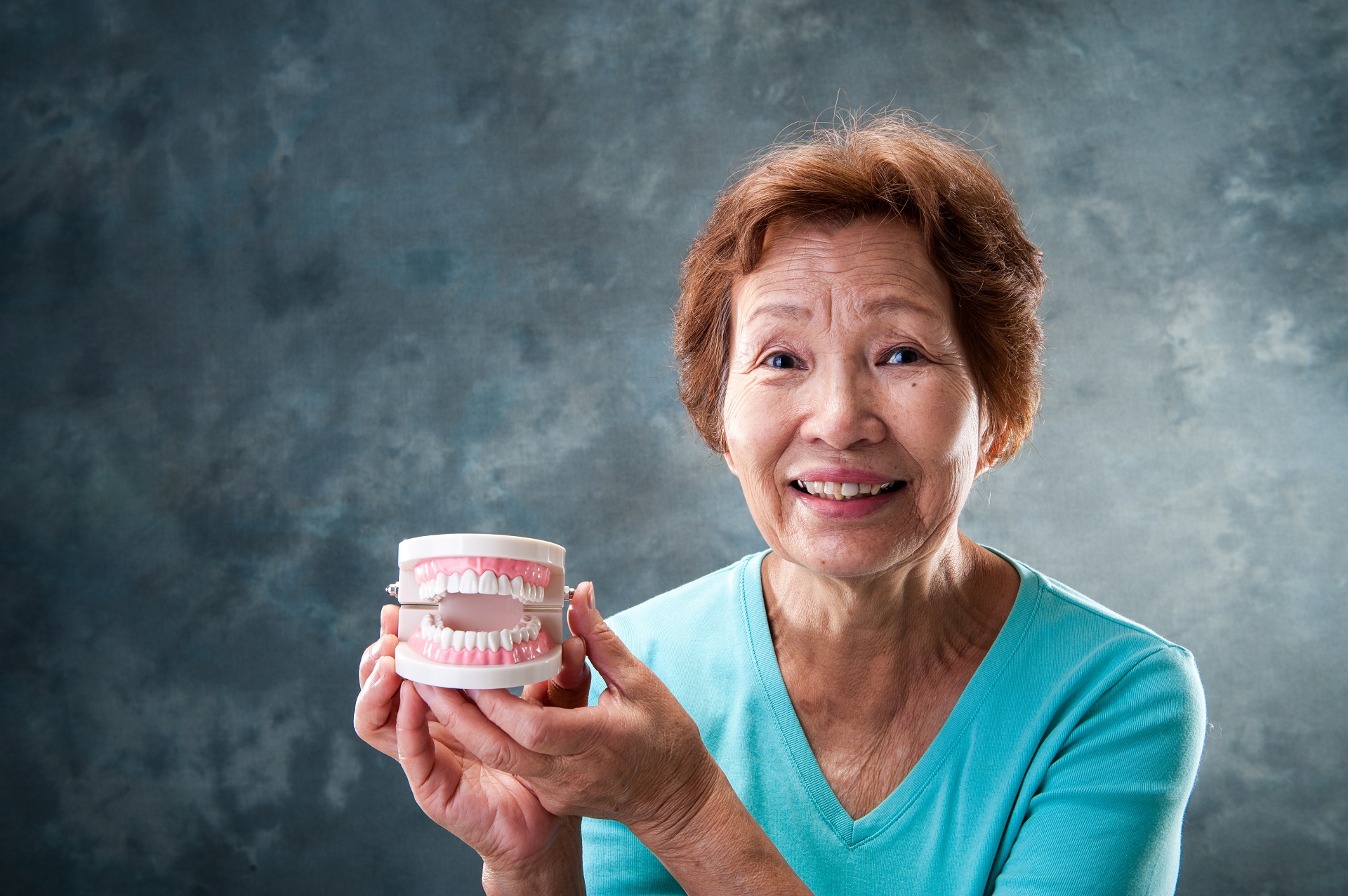 CGH - Good oral care for patients_Elderly woman holds teeth.jpg