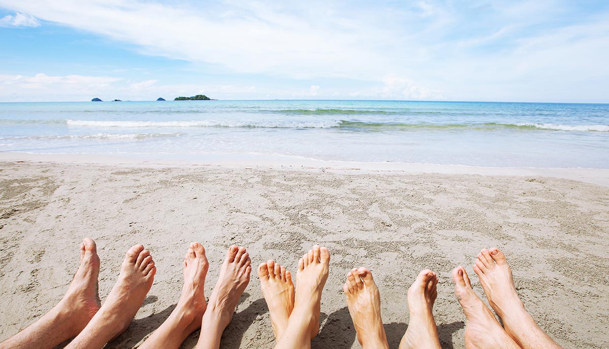 feet-of-family-or-group-of-friends-together-on-beach.jpg