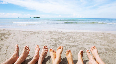 feet-of-family-or-group-of-friends-together-on-beach.jpg