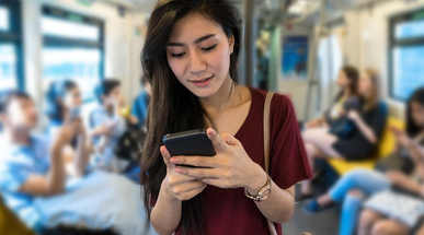 asian-woman-using-mobile-phone-in-the-mrt.jpg
