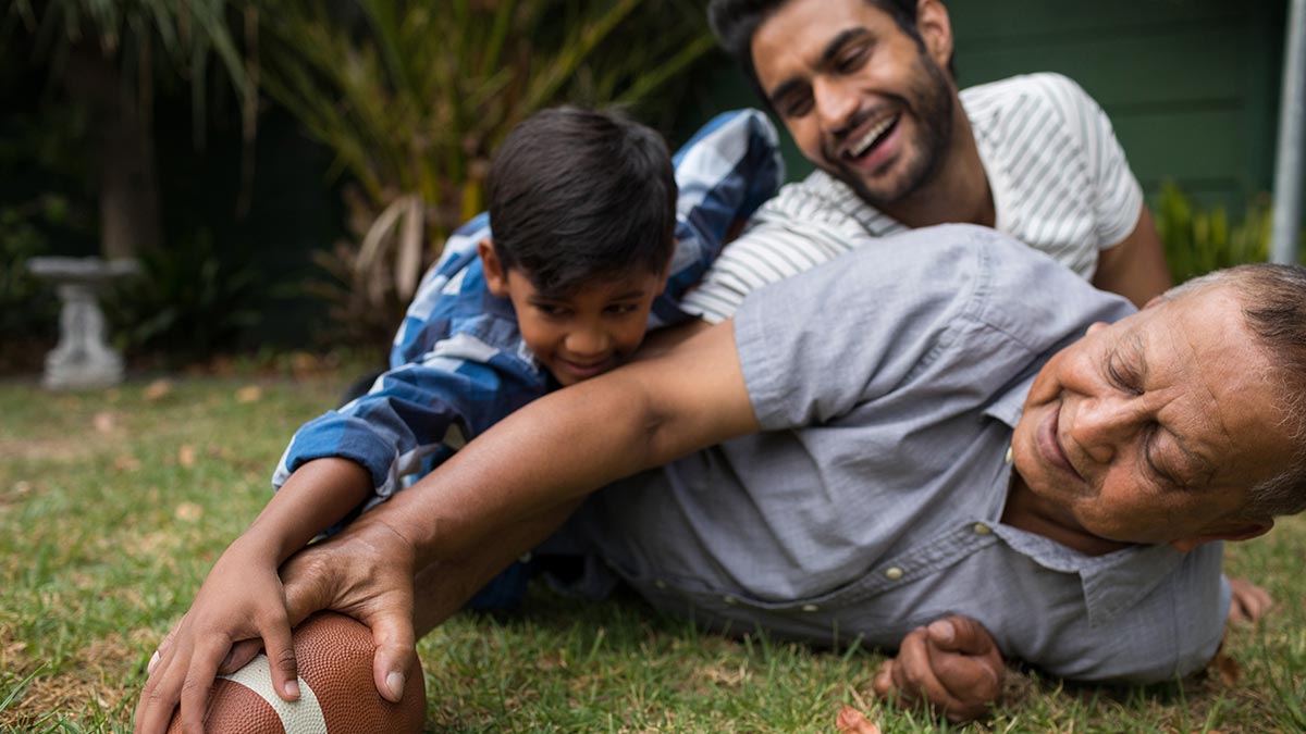 happy-family-playing-american-football-in-yard-together.jpg