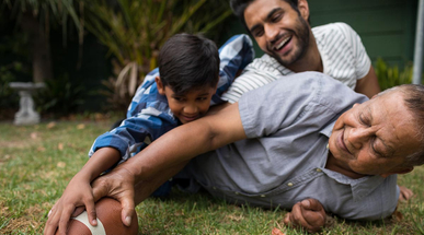 happy-family-playing-american-football-in-yard-together.jpg