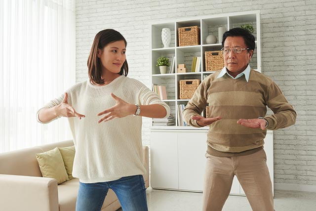 Daughter-father duo practicing tai chi