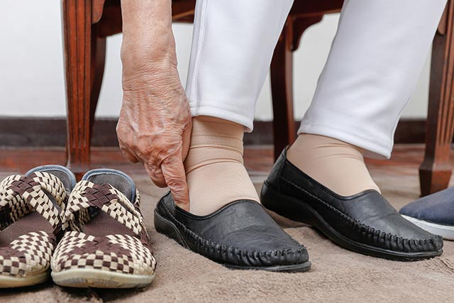 elderly-woman-putting-on-shoes.jpg